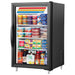 True GDM-07-HC~TSL01 24-inch black single glass door countertop display refrigerator stocked with food