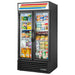 True GDM Series 40-inch black double glass door display refrigerator with swing doors, stocked with groceries