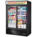 True GDM Series 54-inch black double glass door display refrigerator with sliding doors, stocked with dairy