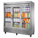 True T-72G-HC~FGD01 78" wide three glass door display refrigerator stocked with milk, eggs and groceries