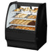 True TGM-DC-36-SC/SC-B-W 36-inch black curved glass dry display case with baked goods on wire shelves
