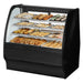 True TGM-DC-48-SC/SC-B-W 48-inch black curved glass dry display case with pastries on wire shelves