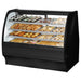 True TGM-DC-59-SC/SC-B-W 59-inch black curved glass dry display case filled with pastries and baked goods