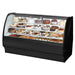 True TGM-R-77-SC/SC-B-W 77-inch black curved glass refrigerated pastry display case filled with desserts
