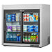 True TSD-09G-HC-LD countertop display refrigerator with sliding glass doors, stocked with drinks and snacks