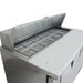 True TSSU-48-12-HC 48" sandwich prep table, close-up of the open lid and empty food pan rail with cutting board