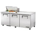 True TSSU-72-18-HC 72" three door stainless steel sandwich prep table with lid open over ingredients, alternate angle