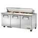 True TSSU-72-18-HC 72" three door stainless steel refrigerated sandwich prep table with lid open over toppings