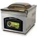 VacMaster VP220 stainless steel countertop chamber vacuum sealing machine with tinted domed lid closed, angled view