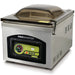 VacMaster VP230 stainless steel countertop chamber vacuum sealing machine with tinted domed lid closed, angled view