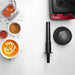 Vitamix 062826 Vita-Prep blender shown from above with tamper, lid, red base and bowls of soup and sauces on white table