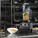 Vitamix 062827 Vita-Prep variable speed blender with chickpeas in the container on a stainless commercial kitchen counter