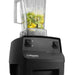 Vitamix 062828 drink blender, close-up of the black base toggle controls with green fruit blending in the container