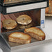 Waring CTS1000CND conveyor toaster, close-up of toasted bagels and bread sliding onto the stainless front tray