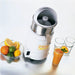 Waring JC4000 high powered citrus juicer with stainless reamer bowl, shown beside citrus fruit and fresh juice