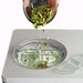 Waring WCIC20 2 quart ice cream maker, pistachios being added through the clear lid during churning