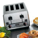 Waring WCT850RC heavy duty four slot stainless steel pop-up toaster shown beside bagels, fruit and breakfast