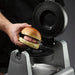 Waring WICSP180 gelato panini press, hand placing a filled brioche bun onto the lower plate
