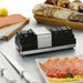 Waring WKS800 electric knife sharpener on a kitchen counter with knives, bread, smoked salmon and fish platter