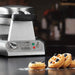 Waring WMB400X mini Belgian waffle maker on a counter with mini waffles topped with blueberries