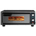 Waring WPO100 medium duty single deck pizza oven, front view with a pizza baking behind the lit window door