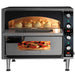 Waring WPO350 double deck pizza oven shown in use with calzones on the top deck and a pizza baking below