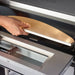 Waring WPO350 double deck pizza oven, close-up of a pizza peel sliding a pie onto the stone deck through the door