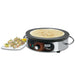 Waring WSC160X 16-inch electric crepe maker with a cooked crepe on the plate beside rolled crepe appetizers
