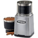 Waring WSG60 3 cup wet and dry spice grinder beside its removable bowl of ground spice and cinnamon sticks