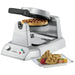 Waring WW180X single Belgian waffle maker with a cooked waffle inside and a plate of waffles and berries