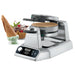 Waring WWCM200 double waffle cone maker with a cooked wafer beside waffle cones filled with ice cream