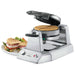 Waring WWD200 double classic waffle maker with a cooked waffle and a plate of waffle sandwiches