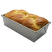 Winco aluminized steel loaf pan with silicone glaze, shown in use with a freshly baked golden bread loaf