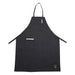 Winco full-length bib apron with pockets in black, front view showing the neck strap, chest pen pocket and waist ties