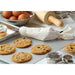 Winco pastry bag shown in use on a bakery counter with cookies on a sheet pan, eggs and a wooden rolling pin