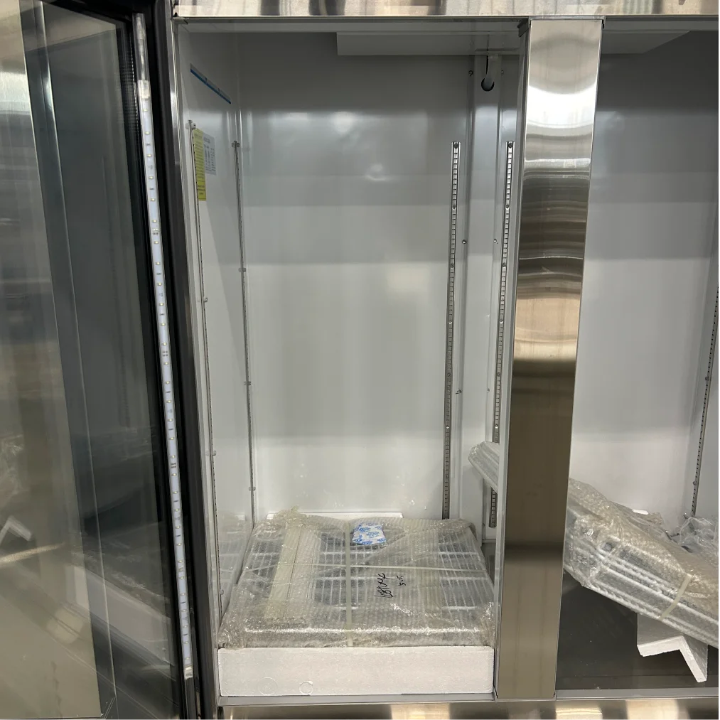 Scratch and dent Nordic Air SGR-48C refrigerator interior, close-up of the left section with the wrapped wire shelves