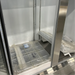 Scratch and dent Nordic Air SGR-48C refrigerator, close-up of new wire shelves still in plastic on the cabinet floor