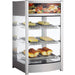 Alpha ADW-97 glass display 18-inch food warmer shown stocked with sandwiches and pastries on three shelves