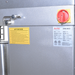 Alpha AVS-40 40 qt commercial spiral mixer, close-up of the red and yellow main power switch, warning label and plate