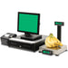 Detecto APS Series retail POS scale weighing bananas beside a point-of-sale monitor, cash drawer and receipt printer