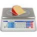 Detecto D Series price computing scale weighing a wedge of cheese, front view of the price keypad and LCD display