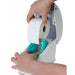 Detecto P225 thermal label printer shown with hands loading a new roll of white labels into the open compartment