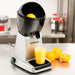 Hamilton Beach 66900 cup size electric citrus juicer on a kitchen counter with fresh orange juice and oranges