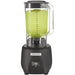 Hamilton Beach HBB908R 44 oz commercial bar blender with clear container of green drink and black base, front