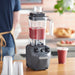 Hamilton Beach HBF510 Expeditor culinary blender/food processor blending a red smoothie on a restaurant counter