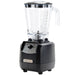 Hamilton Beach HBH650R The Tempest 64 oz commercial blender with clear container and black base, angled left