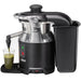 Hamilton Beach HJE960 electric juicer, angled view with the black pulp bin attached and a glass of green juice