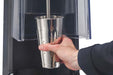 Hamilton Beach HMD1000 MixStation manual drink mixer, hand placing a stainless steel cup onto the spindle
