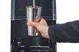 Hamilton Beach HMD1000 MixStation manual drink mixer, hand holding a stainless steel mixing cup under the spindle