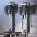 Two Hamilton Beach HMD300 wall-mounted single-spindle drink mixers installed side by side on a steel wall